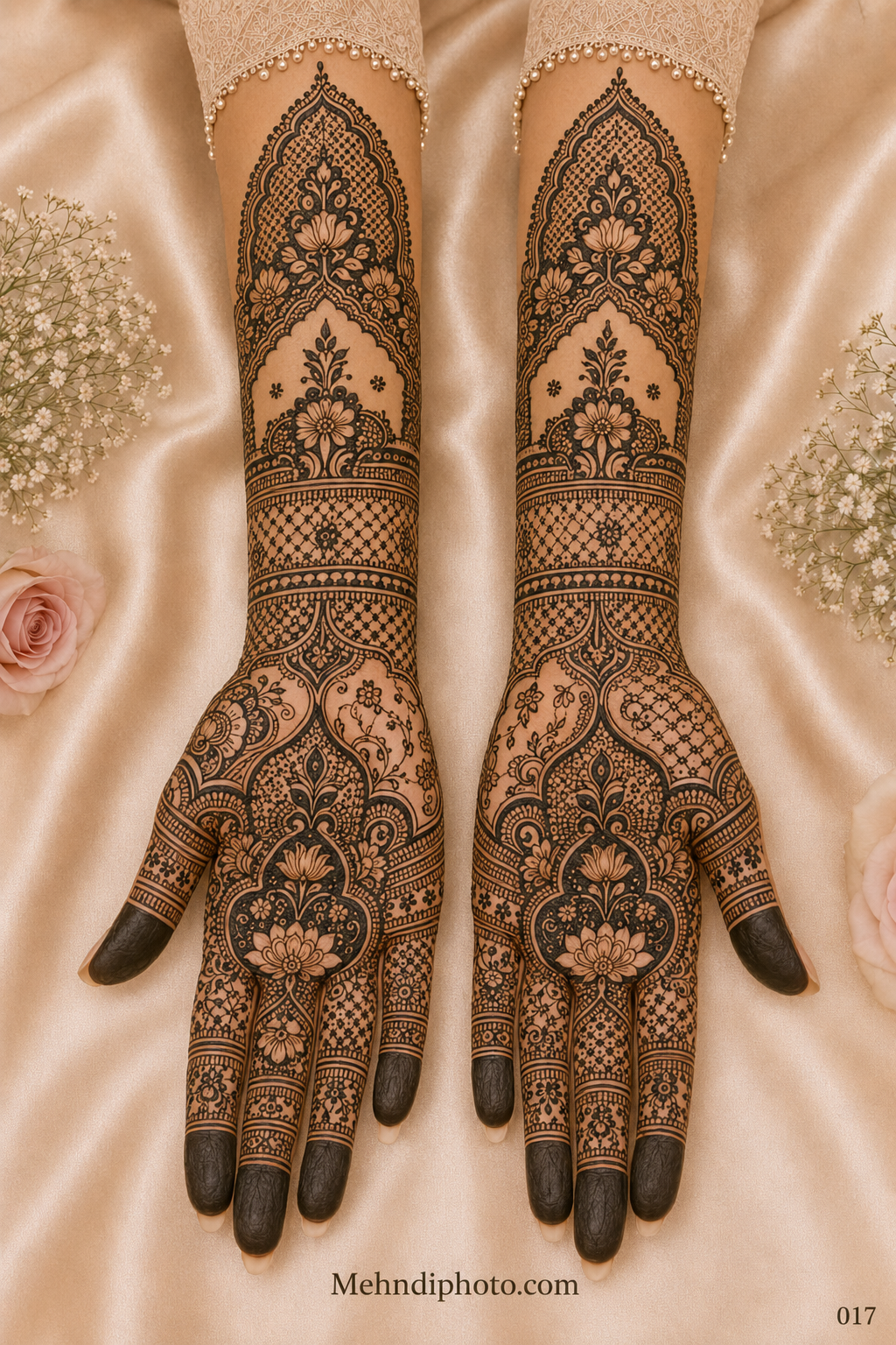 Full hand bridal mehndi design on both palms and forearms featuring lotus arch motifs, floral jaali patterns, paisley details and dark fingertips.