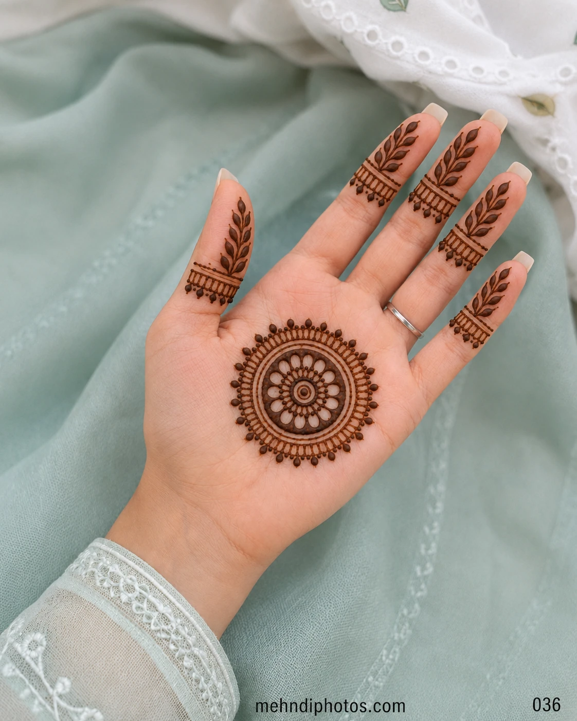 Discover an elegant front hand mehndi design with a floral mandala, leafy fingers and hanging details, ideal for Eid, Teej and festive occasions.