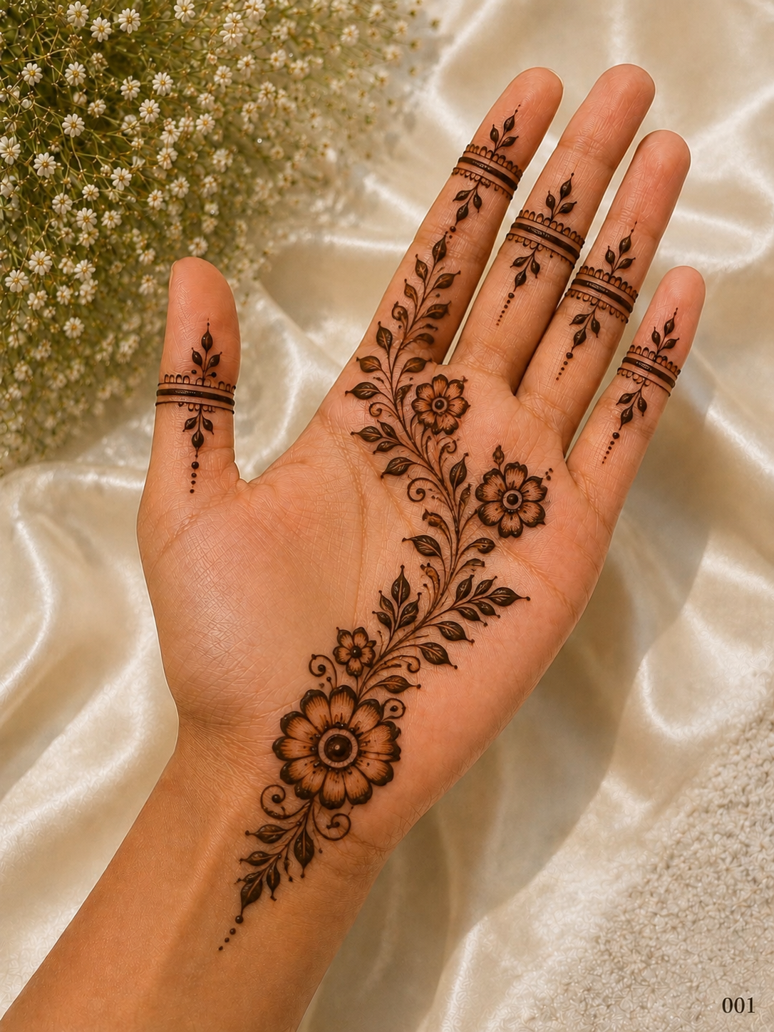 Simple front hand mehndi design with a diagonal floral vine, shaded flowers, leafy branches and minimal bands on all fingers.
