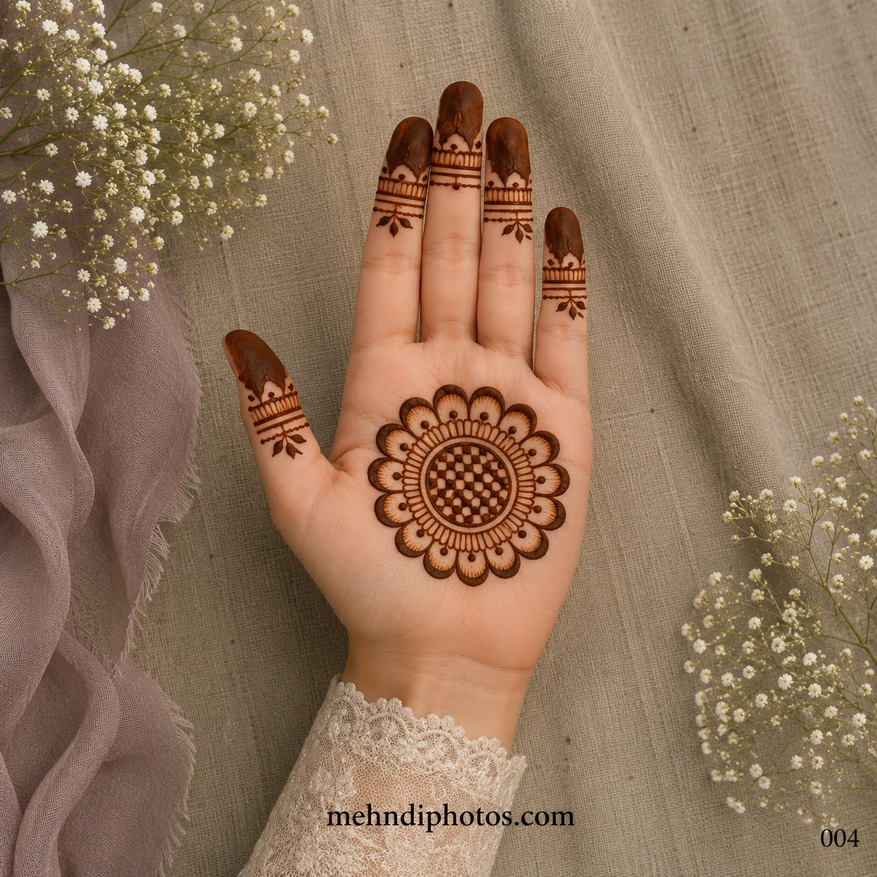 Simple flower finger mehndi design with a floral tikki mandala, geometric center, elegant finger bands, and dark fingertip henna on a palm in traditional Indian style.