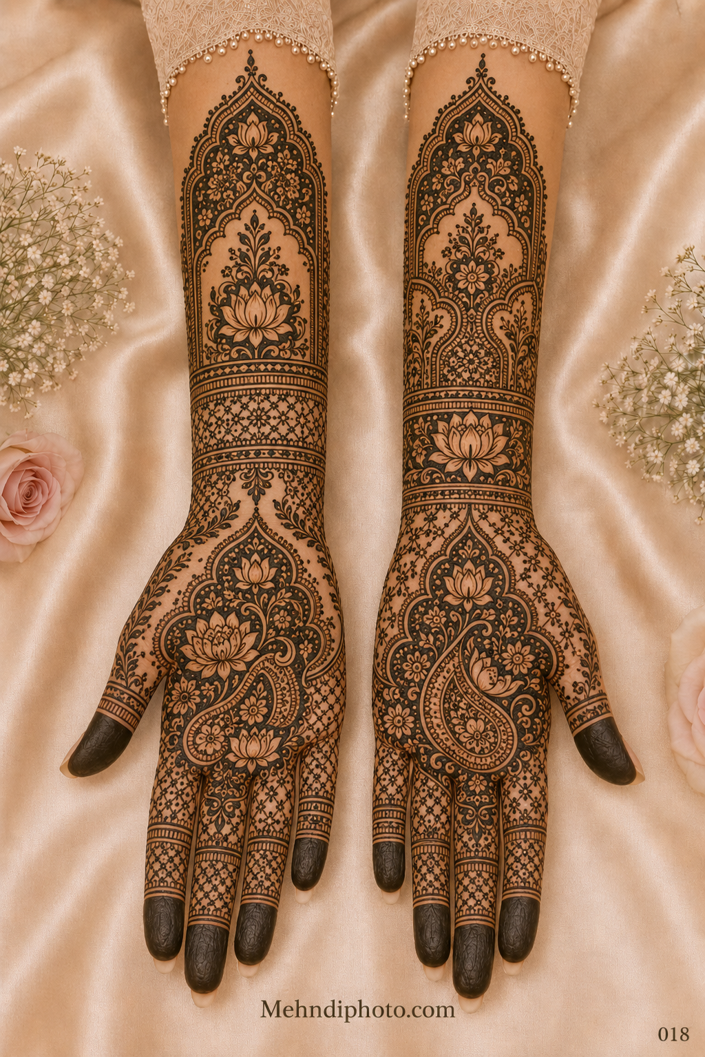 Full hand bridal mehndi design on both palms and forearms featuring lotus-filled paisley motifs, floral arches, jaali patterns and dark fingertips.