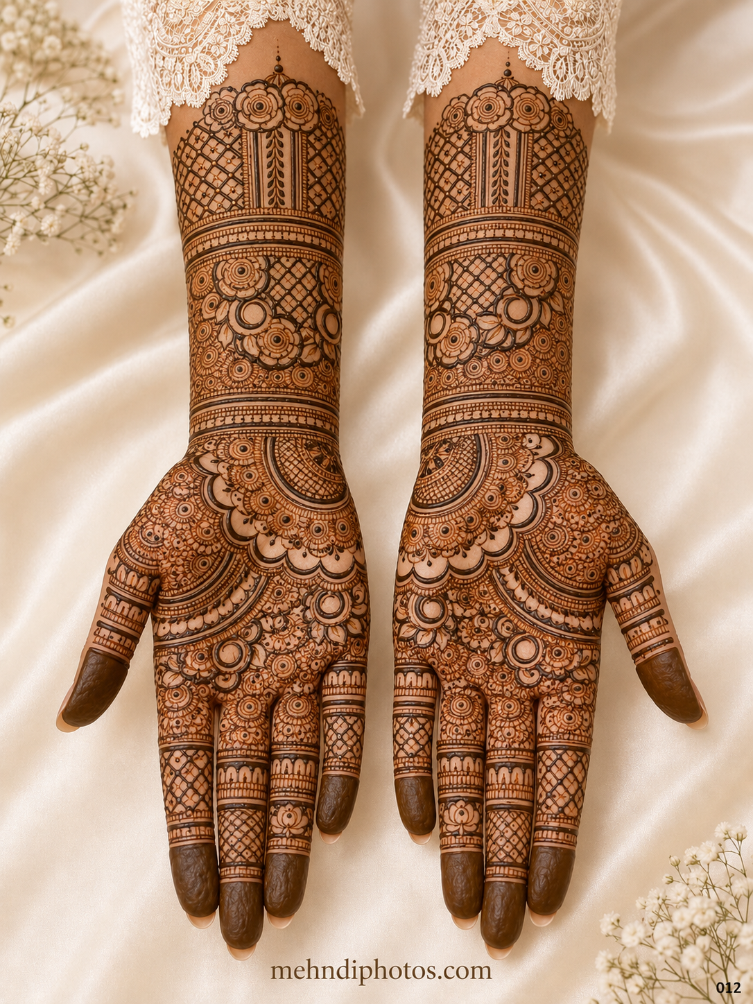 Full hand bridal mehndi design on both palms and forearms featuring floral motifs, diamond jaali patterns, ornamental bands and shaded fingertips.