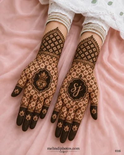 Engagement full hand mehndi design with floral jaali patterns, lotus motifs, a kalash and personalized initials on the palms.