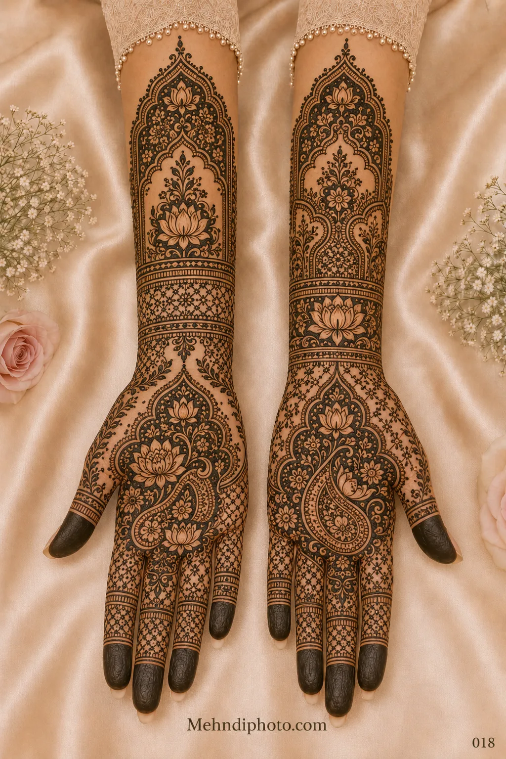 Full hand bridal mehndi design on both palms and forearms featuring lotus-filled paisley motifs, floral arches, jaali patterns and dark fingertips.
