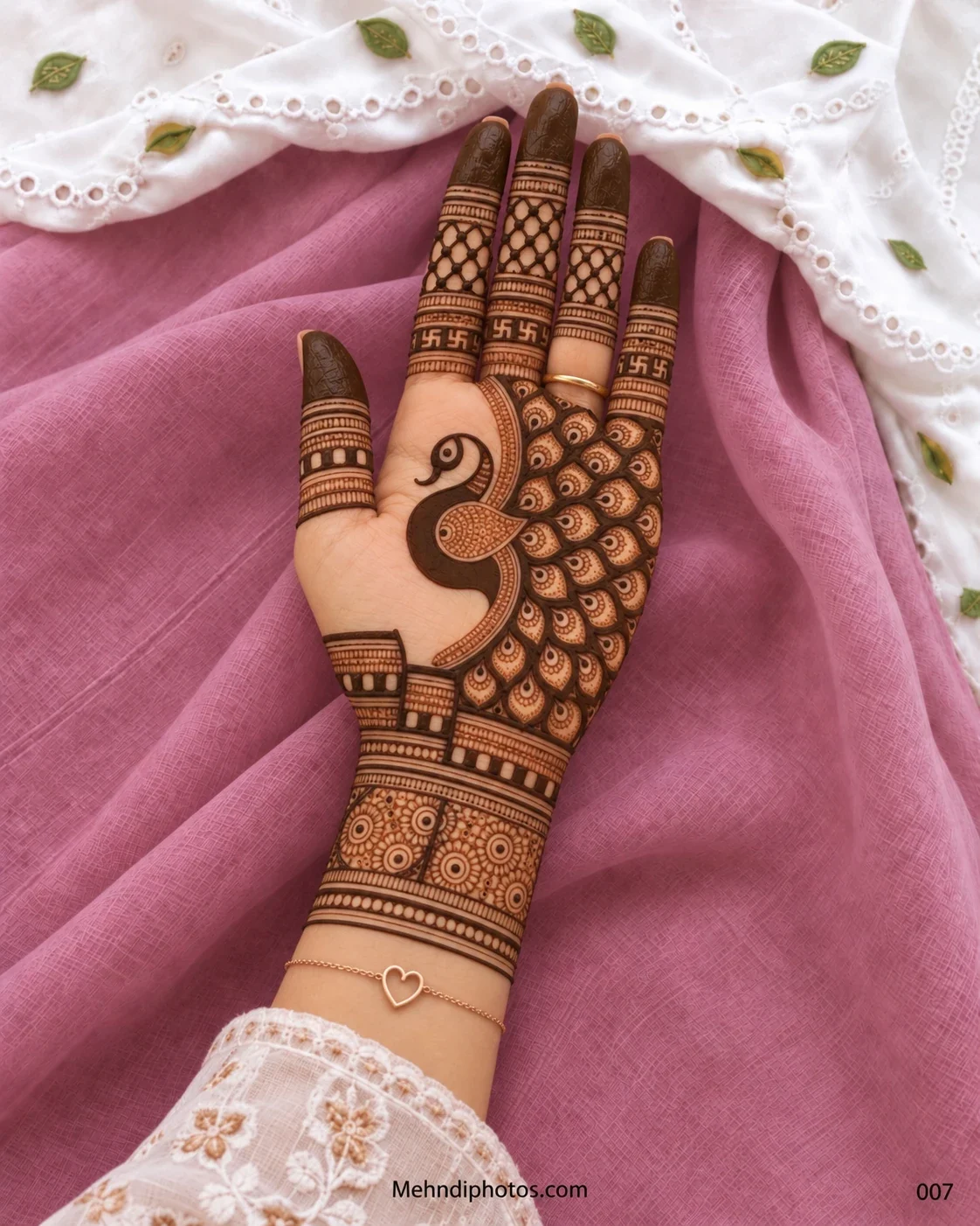 Diwali front hand mehndi design featuring a large peacock, layered teardrop feathers, netted fingers, traditional swastika bands, and ornate wrist details.