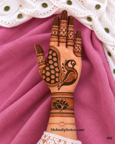 Diwali front hand mehndi design featuring a bold peacock with a patterned wing, netted finger bands, dark fingertips, and a lotus wrist motif.