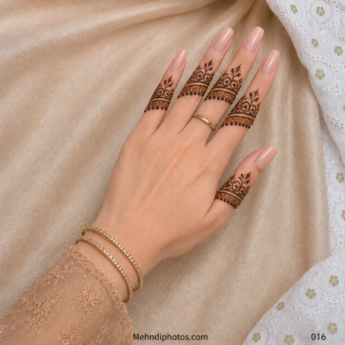 Back hand with ornamental mehndi bands featuring curved scrolls, small leafy accents and hanging dots across every finger.