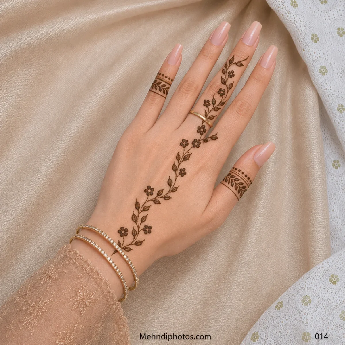 Back hand with a diagonal vine of small flowers and leaves, plus matching leafy mehndi bands on the thumb and little finger.