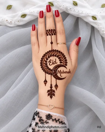 Eid back hand mehndi featuring Eid Mubarak lettering inside a leafy wreath with a decorated crescent moon, hanging charms, and red nails.