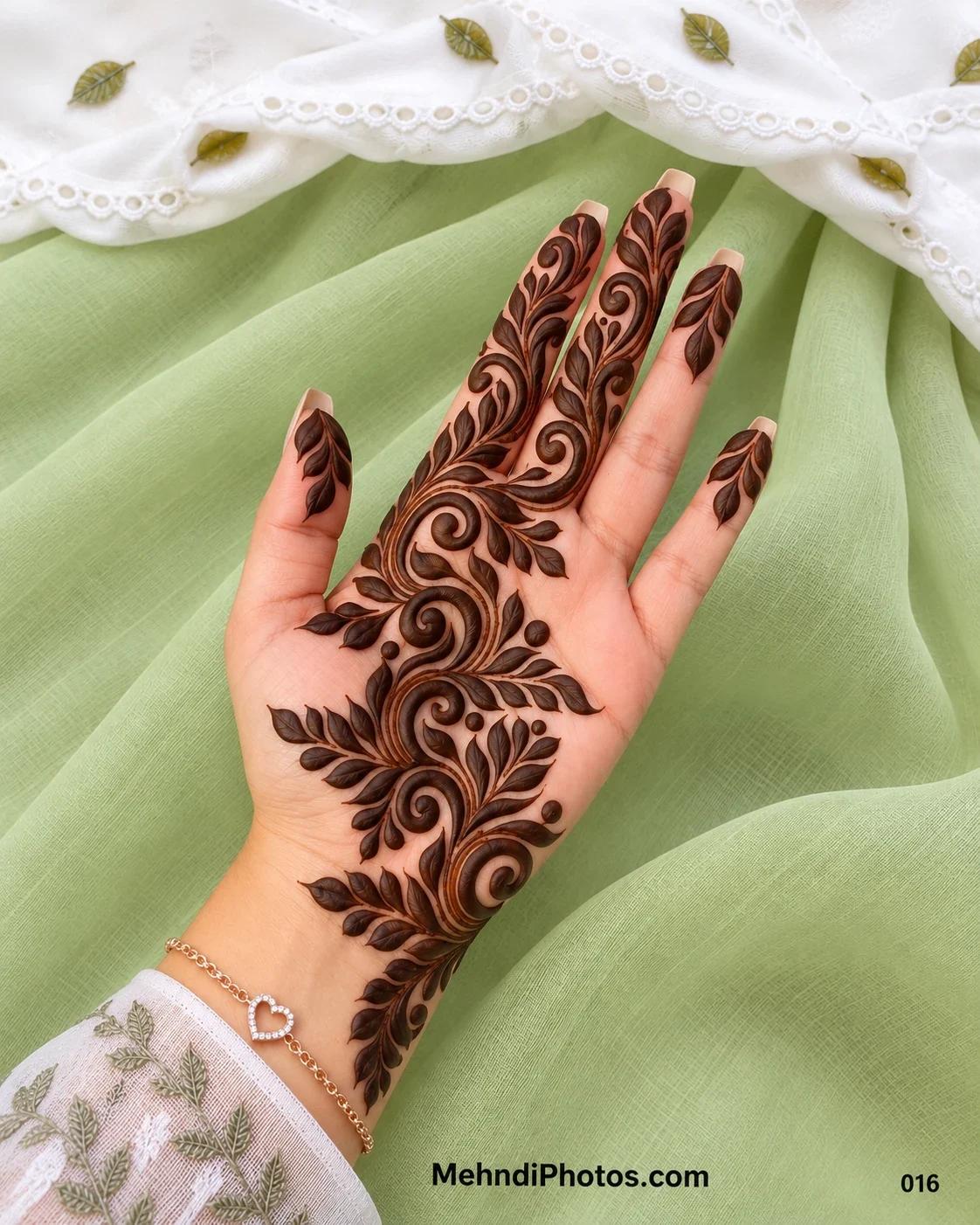 Front hand mehndi design with bold raised spirals, flowing leafy branches, dark henna strokes, and a diagonal Arabic-style pattern.