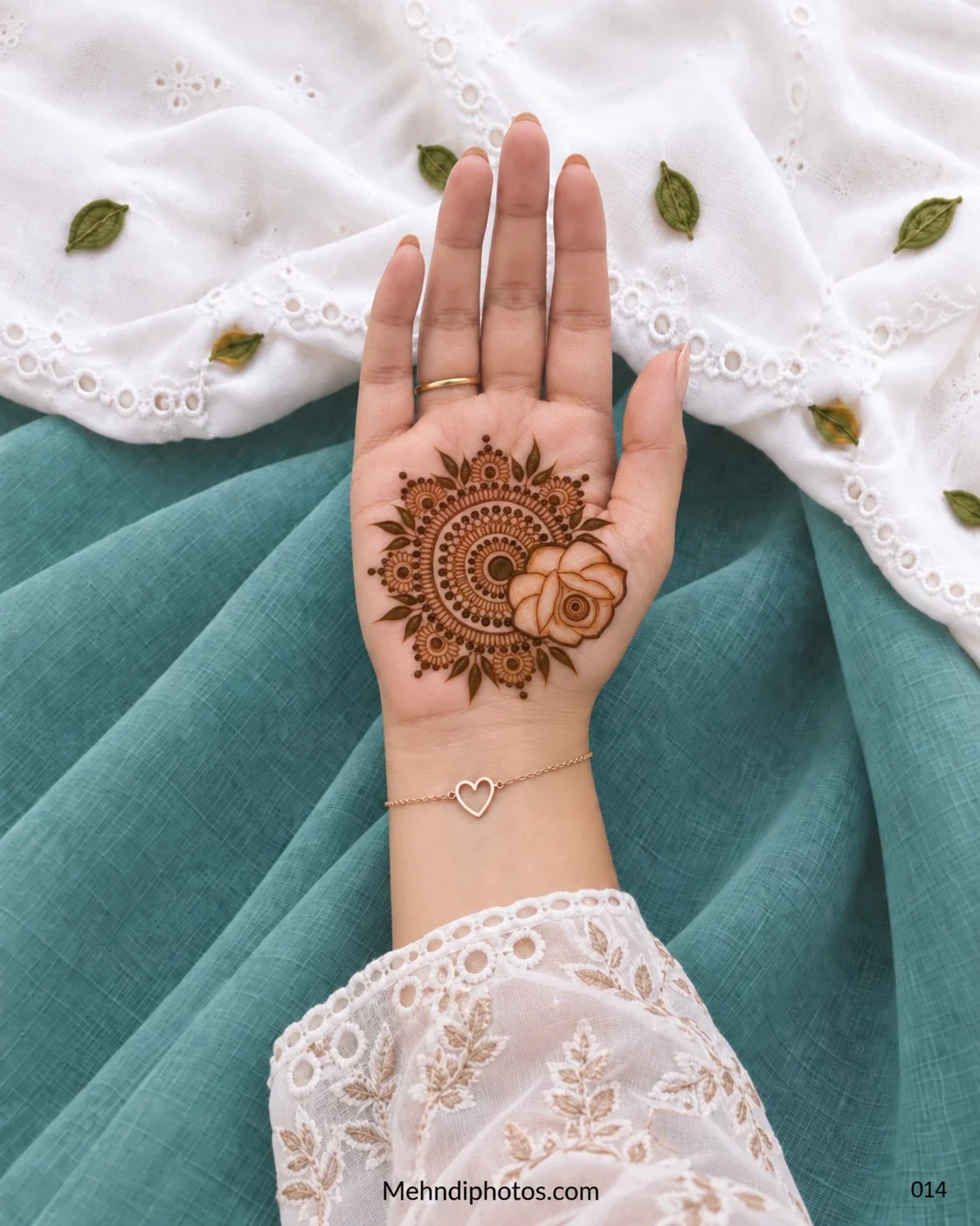 Front hand with floral gol tikki mandala and large outlined rose