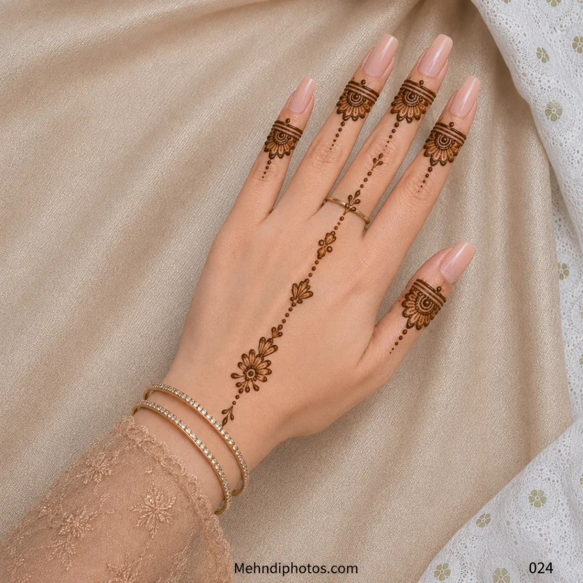 Back hand with matching semicircular floral finger bands, fine dotted trails and a delicate flower-and-leaf chain extending from the wrist.