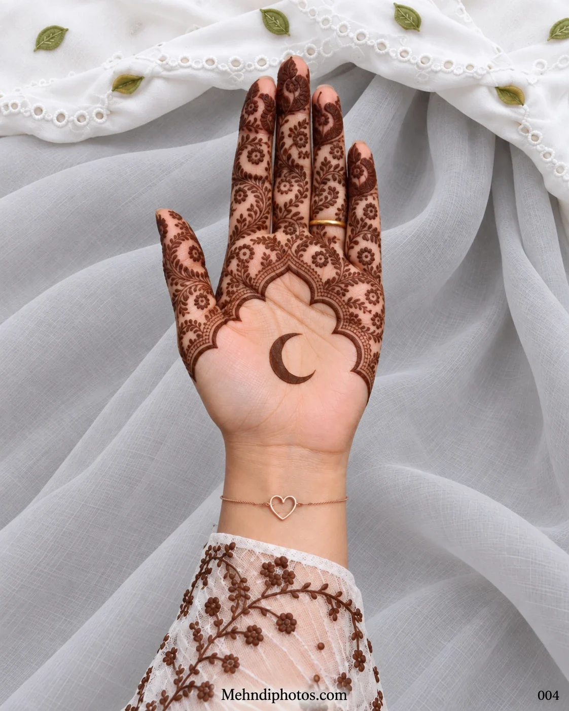 Eid front hand mehndi design featuring a crescent moon on an open palm beneath a scalloped arch filled with floral vines, leaves, and paisley details.