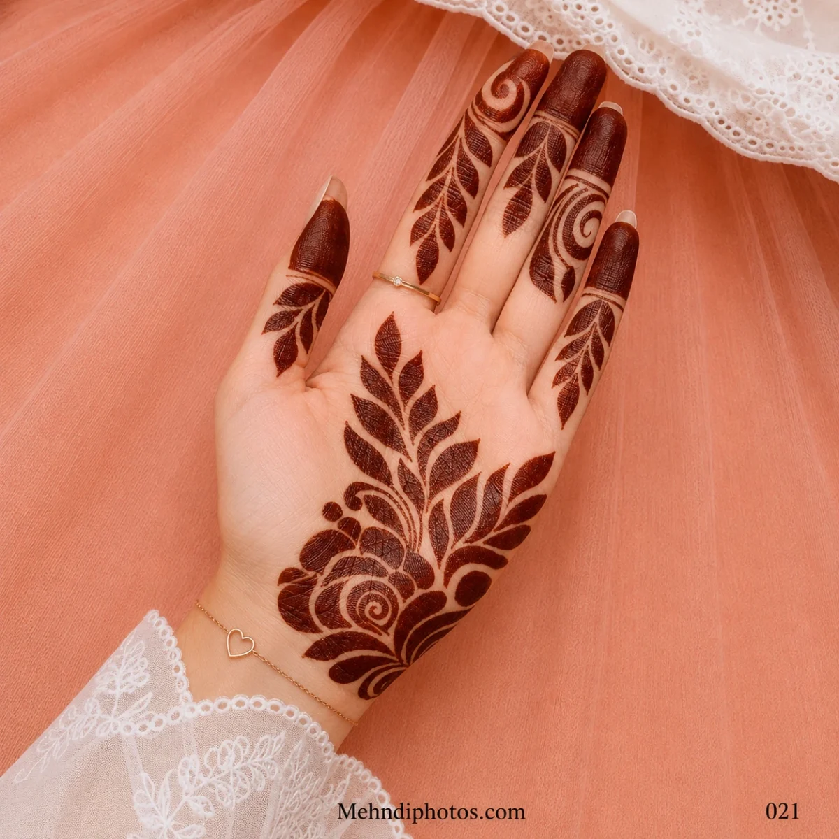 Front hand with a bold rose mehndi motif, sweeping leafy branches, curved vines and dark filled fingertips.