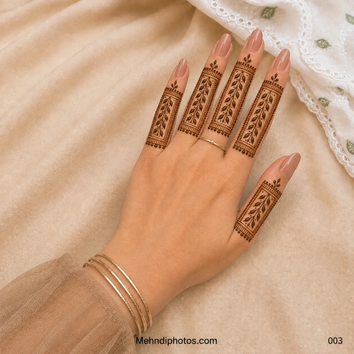 Back hand featuring rectangular finger mehndi panels with leafy vines, fine borders and delicate dotted details.