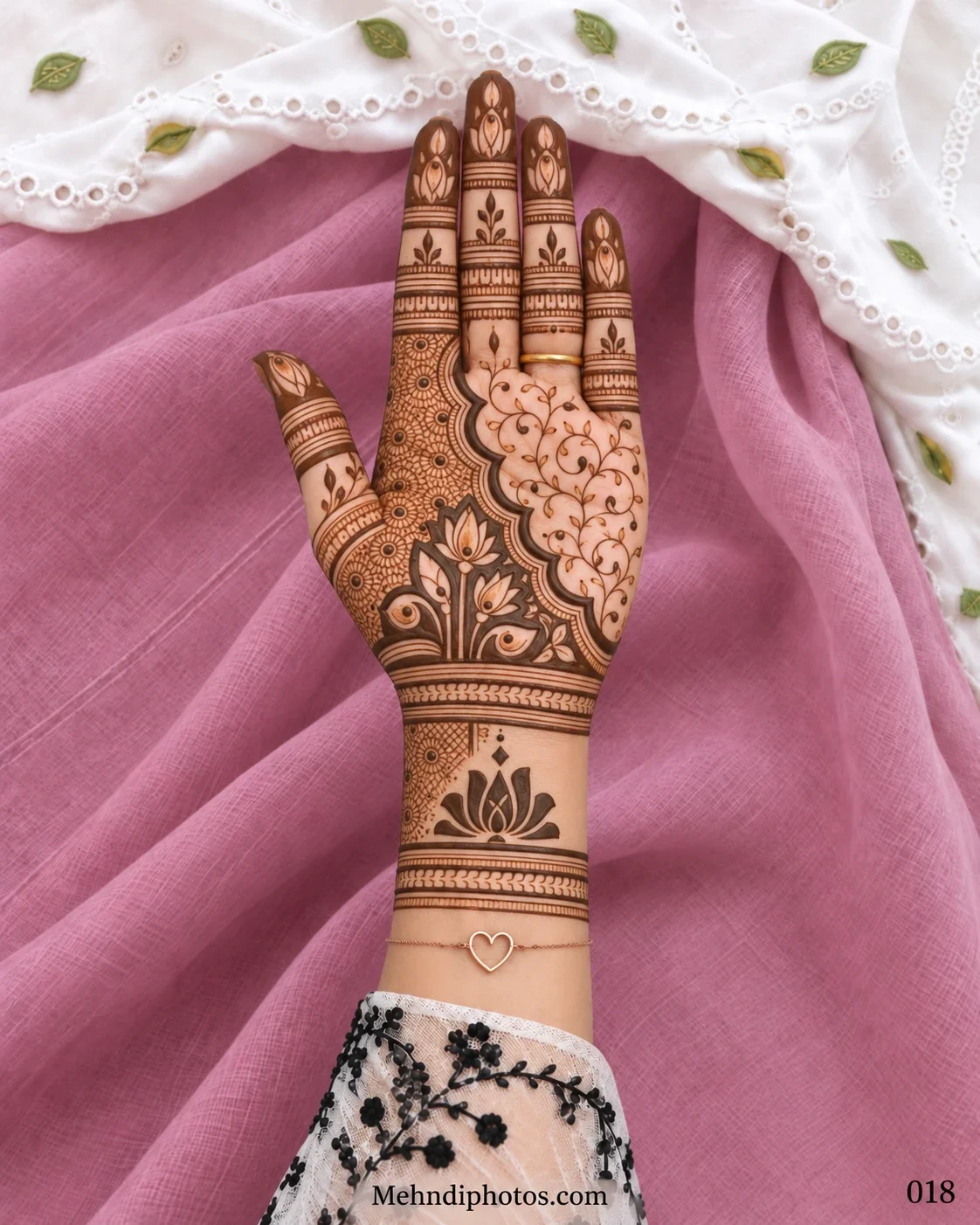 Elegant Diwali front hand mehndi with floral lacework, an open vine pattern, scalloped border, lotus fingers, ornamental bands, and a framed wrist lotus.