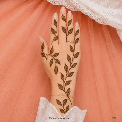 Back hand with long flowing leafy mehndi vines extending from the wrist toward the fingers, featuring detailed inner leaf veins.