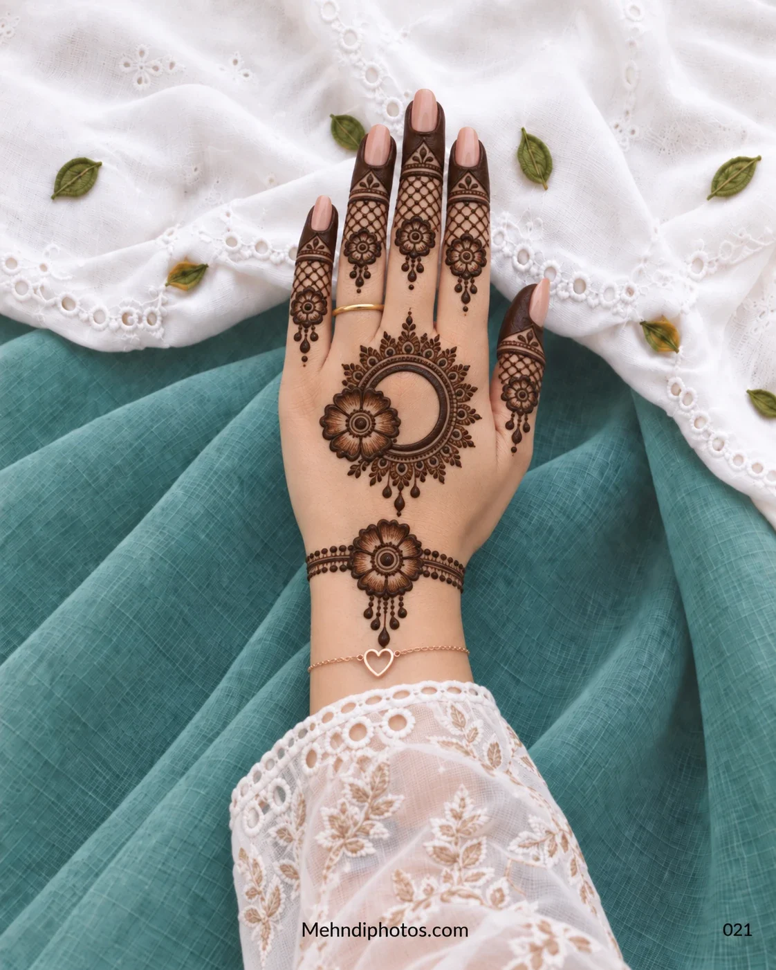 Back-hand mehndi with crescent gol tikki, shaded flowers, lattice fingers, and droplet details