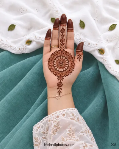 Front hand with detailed floral gol tikki, vine motifs, and shaded fingertips