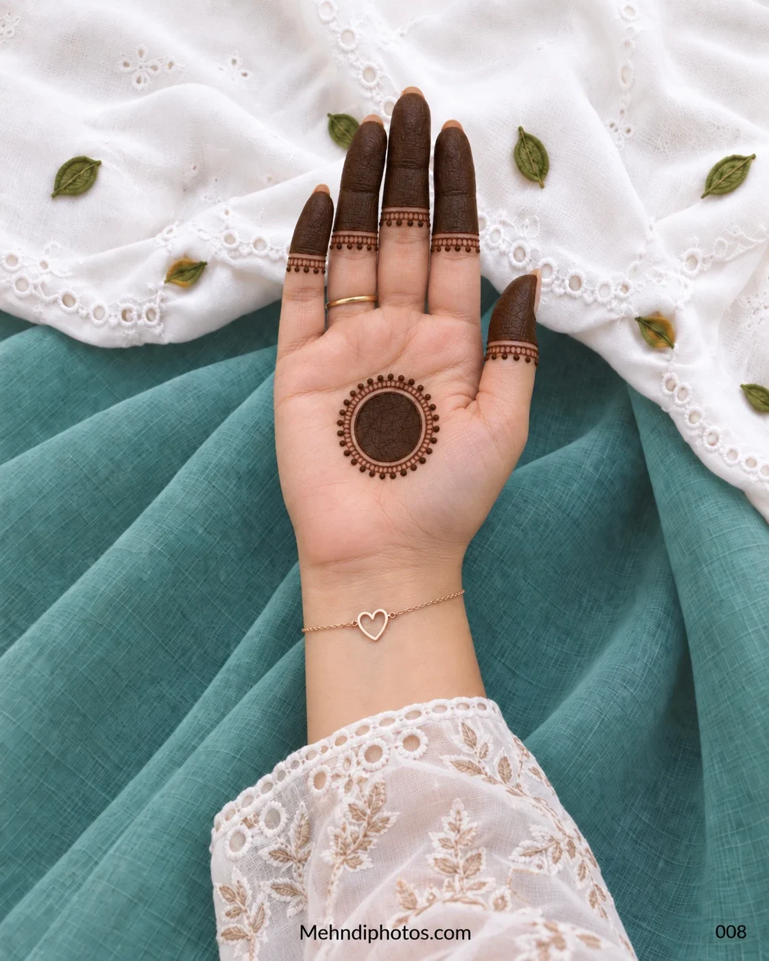 Front hand with beaded circular gol tikki and shaded fingertips