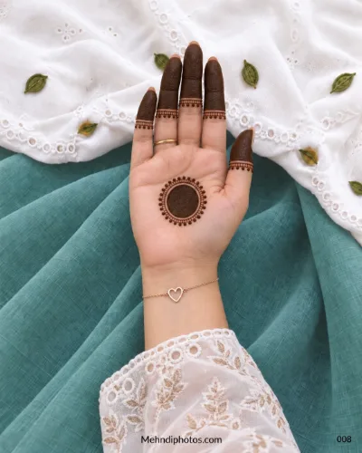 Front hand with beaded circular gol tikki and shaded fingertips