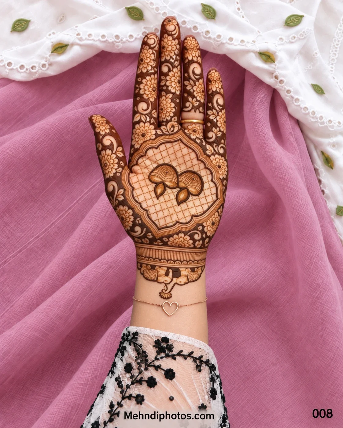 Diwali front hand mehndi design with paired paisley motifs, a scalloped lattice frame, dark floral fingers, swirling leaves, and elephants near the wrist.