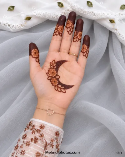 Simple Eid front hand mehndi design featuring a floral crescent moon with leafy accents, matching flower motifs on the fingers, and dark fingertips.