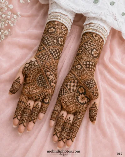 Engagement full hand mehndi design featuring floral motifs, checkerboard patterns, curved bands and intricate geometric details.