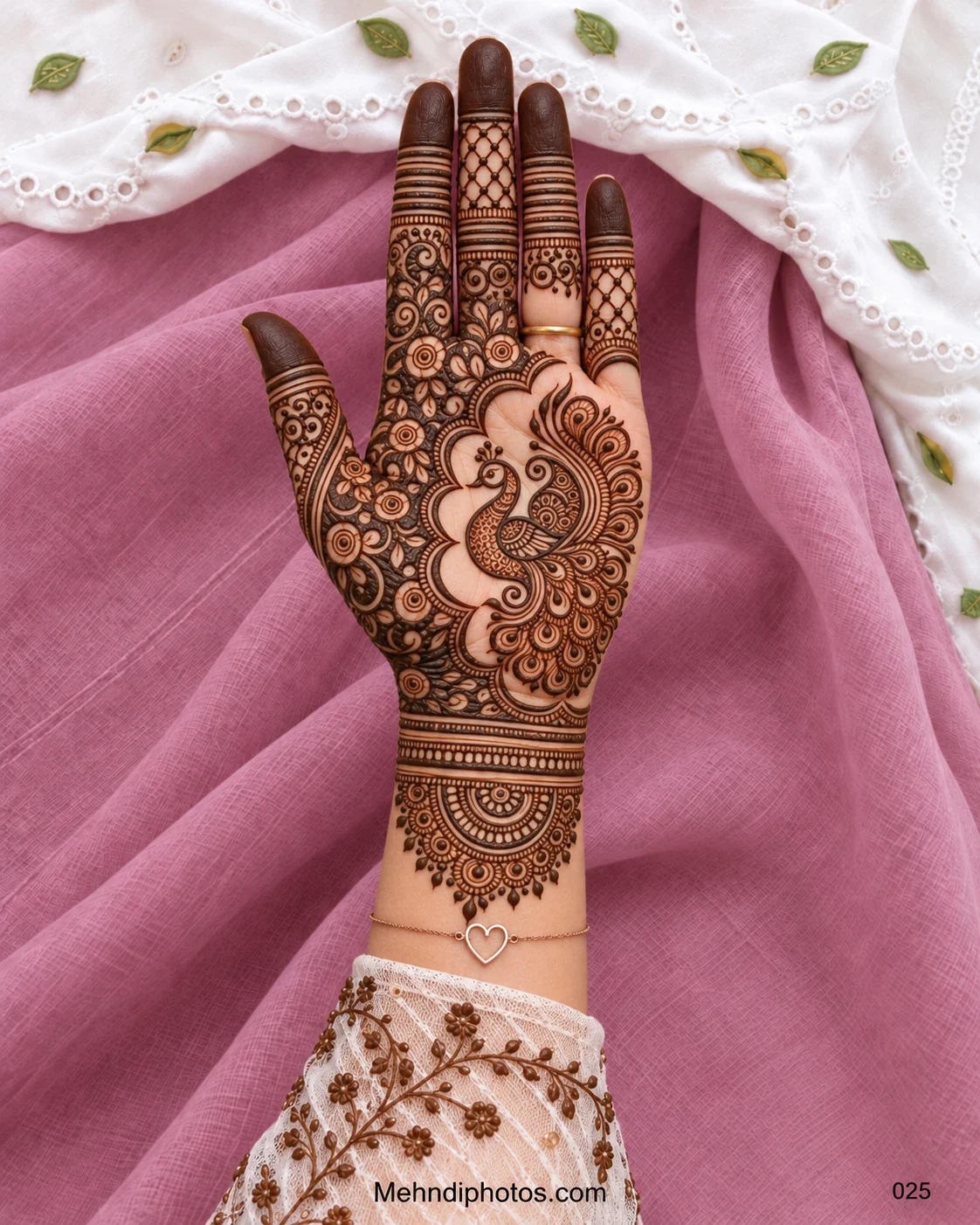 Diwali front hand mehndi design featuring a detailed peacock, sweeping feather motifs, dense floral filling, netted fingers, dark tips, and a layered wrist mandala.