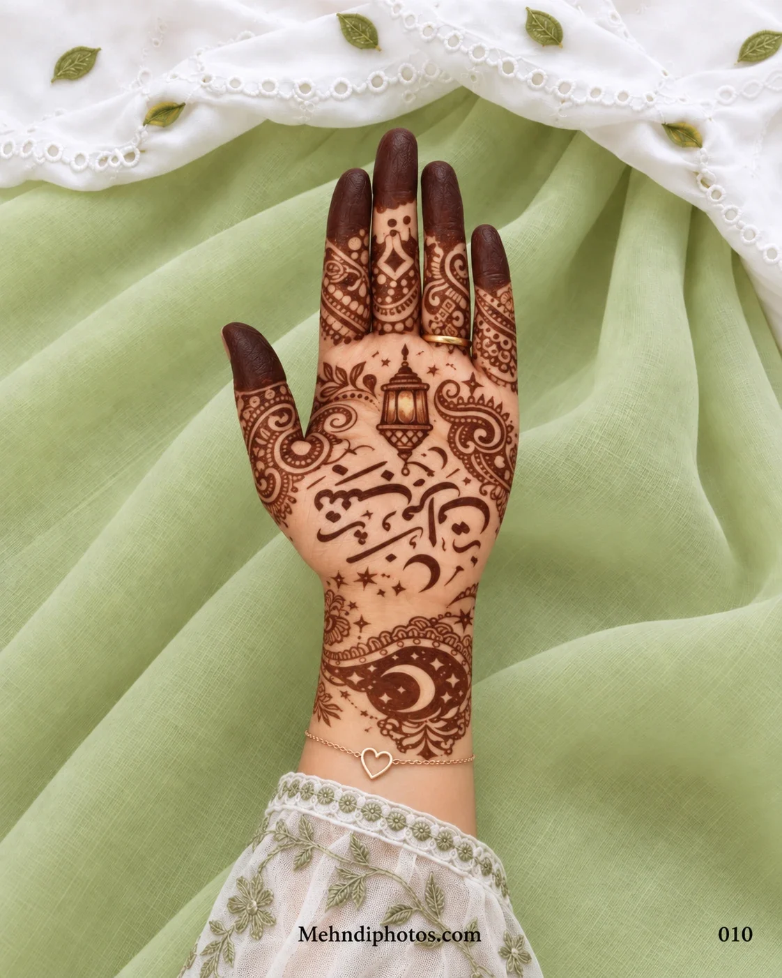 Front hand with Eid Mubarak Arabic calligraphy, a hanging lantern, crescent moons, stars, paisley borders and dark filled fingertips.
