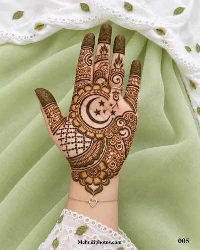 Front hand with a detailed Muslim mehndi design featuring a crescent moon, stars, floral petals, latticework, swirls and dark fingertips.