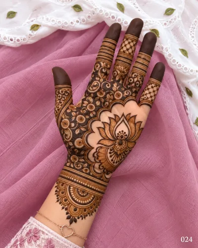 Diwali front hand mehndi design featuring a large shaded lotus, scalloped arches, dense floral and paisley filling, netted fingers, and a wrist mandala.